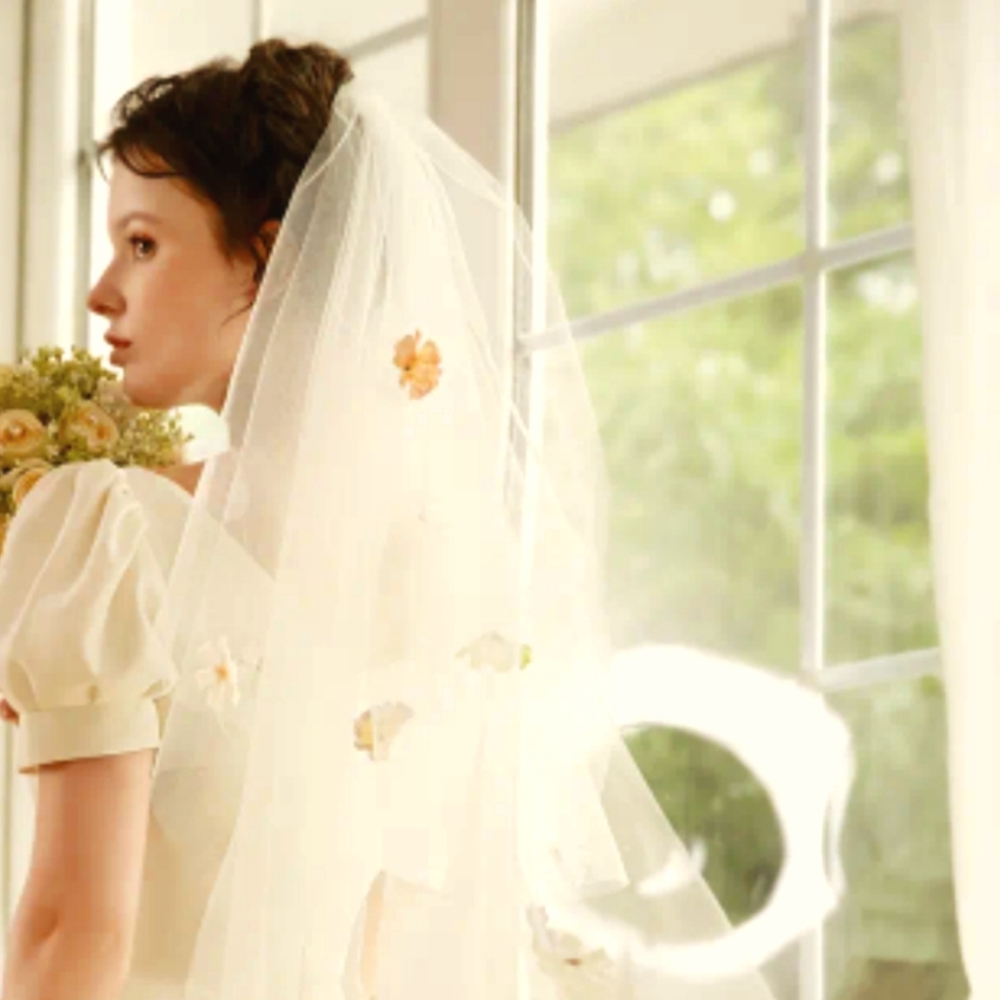 Two layers of gentle pastel flowers with creamy white veil.
